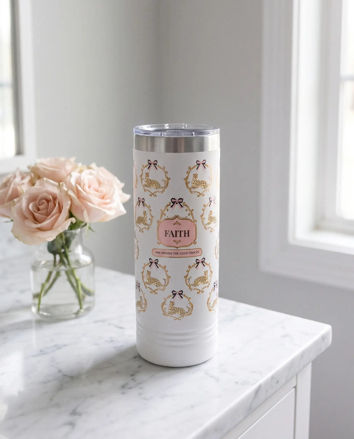 Cheetah Damask, Good Snacks wrap on a white 22oz Skinny tumbler personalized FAITH, a marble vanity top in a softly lit dressing room