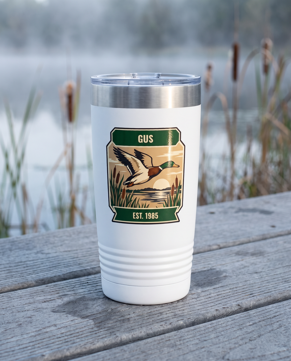 Duck Blind, Duck Stamp badge on a white 20oz tumbler personalized GUS, EST. 1985, a weathered wooden dock over a misty marsh