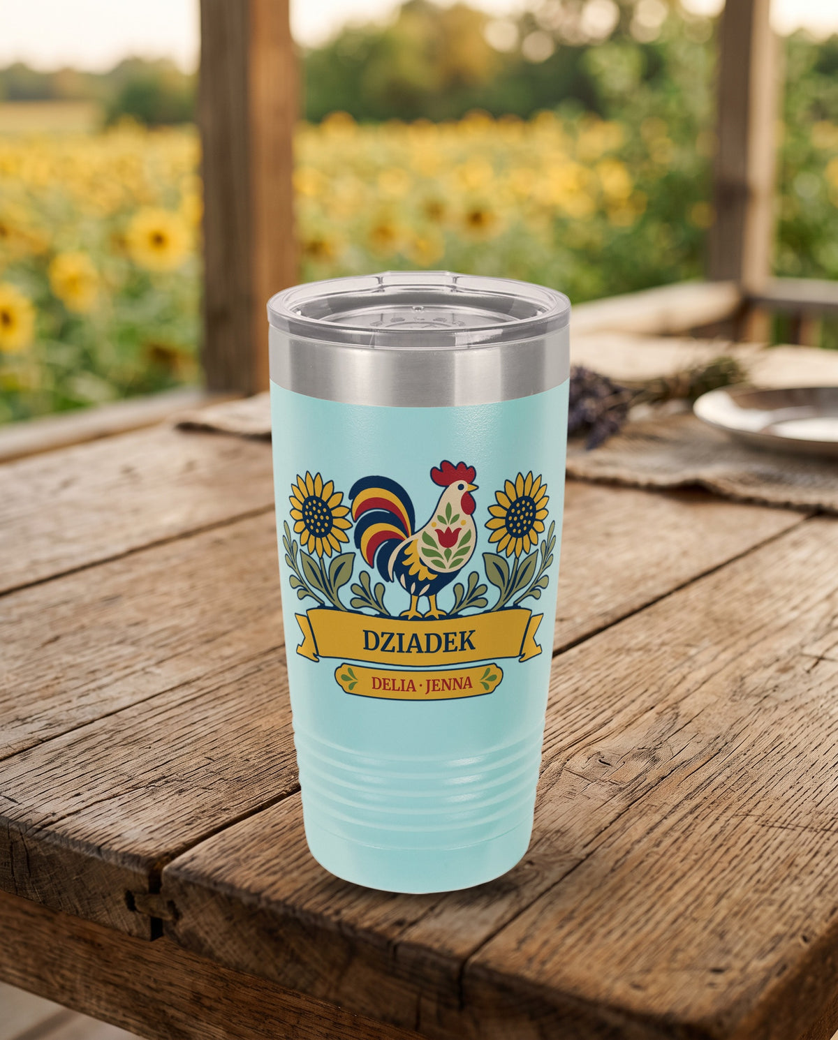Sunflower Rooster, a folk rooster and sunflowers in red, gold, navy, cream and sage, UV printed on the front of a 20oz Ringneck tumbler in Light Blue, sample name DZIADEK