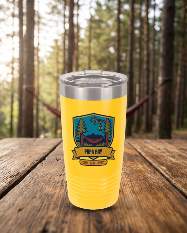Hammock Pines Badge, a hammock and pines badge in blue, green, red, gold and navy, UV printed on the front of a 20oz Ringneck tumbler in Yellow, sample name PAPA RAY