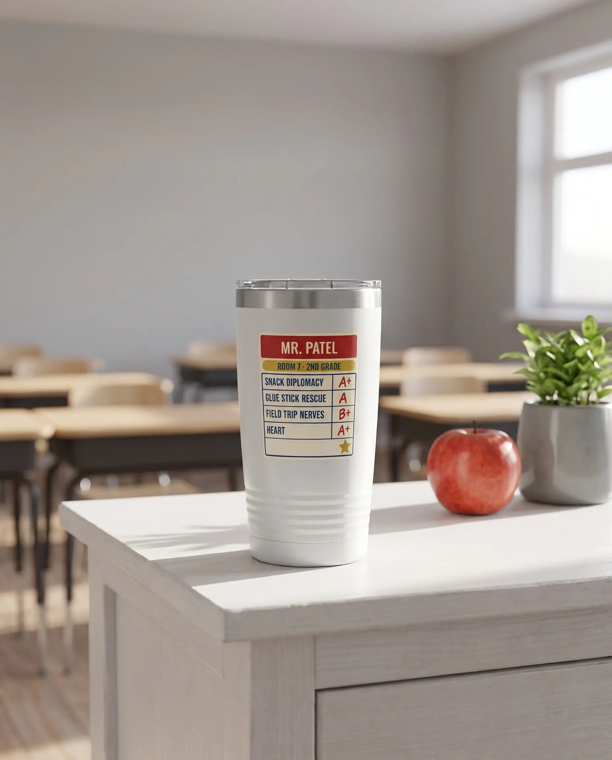 Teacher Report Card, Snack Diplomacy badge on a white 20oz tumbler personalized MR. PATEL, ROOM 7 - 2ND GRADE, a white-painted teacher's desk by a sunny classroom window