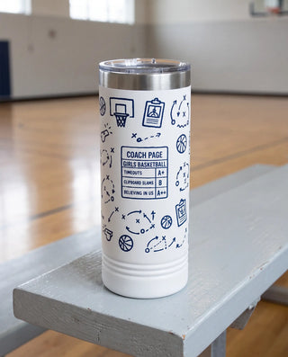 Coach Chalk Talk, Basketball wrap on a white 22oz Skinny tumbler personalized COACH PAGE, GIRLS BASKETBALL, the pale gray bleacher bench of a school gym