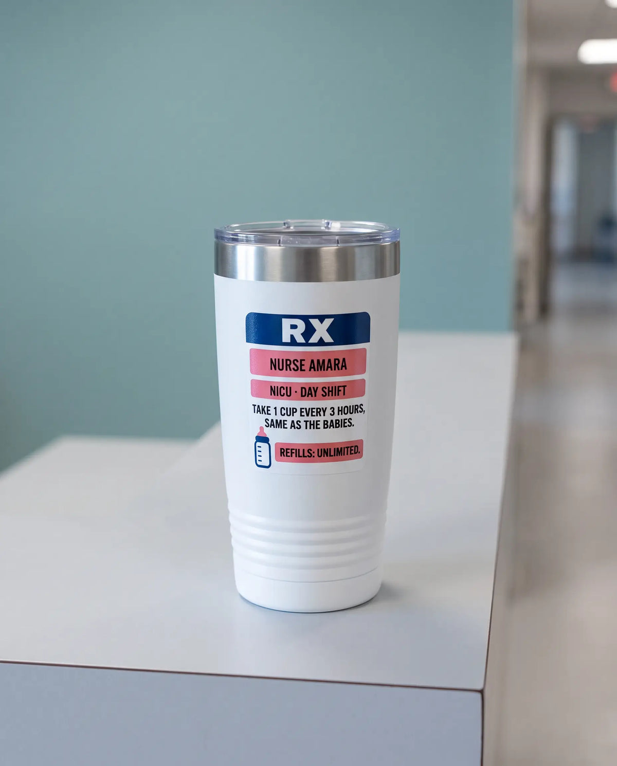 Rx Label, NICU Nurse badge on a white 20oz tumbler personalized NURSE AMARA, NICU - DAY SHIFT, a clean hospital nurses' station counter