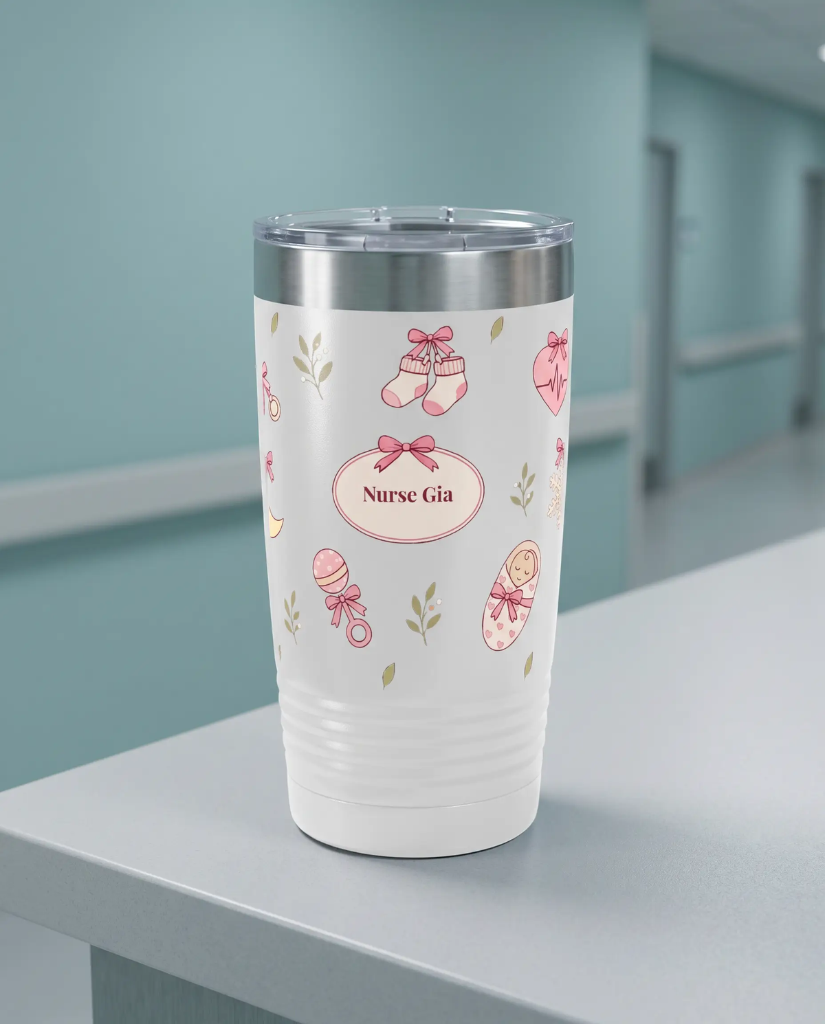 Bow Toss, L&D Nurse wrap on a white 20oz tumbler personalized Nurse Gia, a clean hospital nurses' station counter