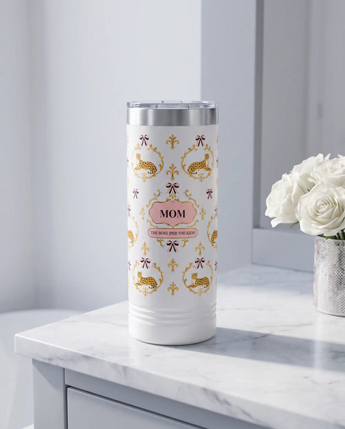 Cheetah Damask, The Boss wrap on a white 22oz Skinny tumbler personalized MOM, a marble vanity top in a softly lit dressing room
