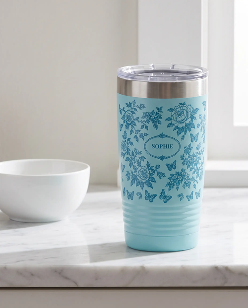 Botanical Toile, Tone on Tone wrap on a light blue 20oz tumbler personalized SOPHIE, three-quarter view showing the ribbed lower wall, a white marble kitchen counter