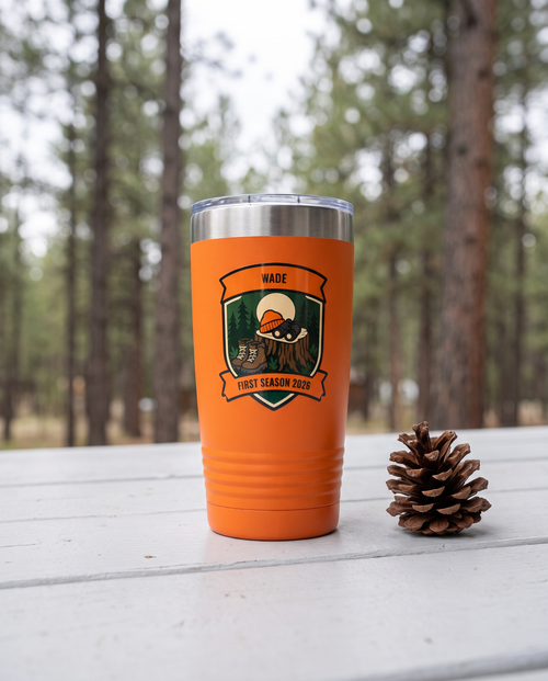 Deer Camp Patch, First Season badge on an orange 20oz tumbler personalized WADE, FIRST SEASON 2026, a white-painted table on a cabin porch