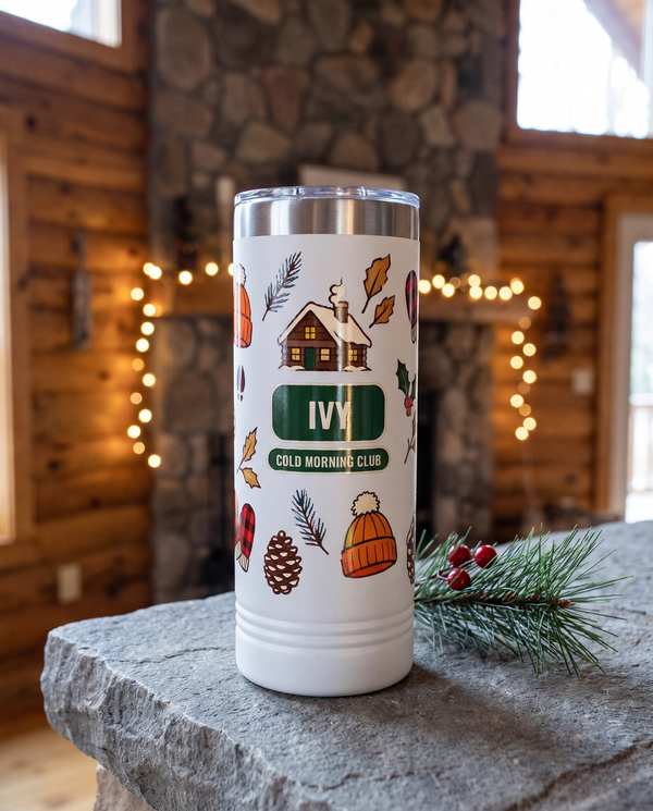Deer Camp Winter, Cold Morning Club wrap on a white 22oz Skinny tumbler personalized IVY, COLD MORNING CLUB, a stone mantel in a log cabin at Christmas