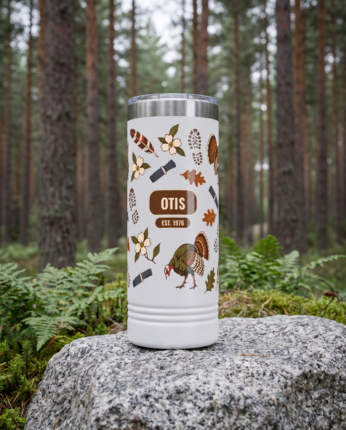 Turkey Gobbler, Est. Year wrap on a white 22oz Skinny tumbler personalized OTIS, EST. 1976, a granite boulder among ferns in a pine forest