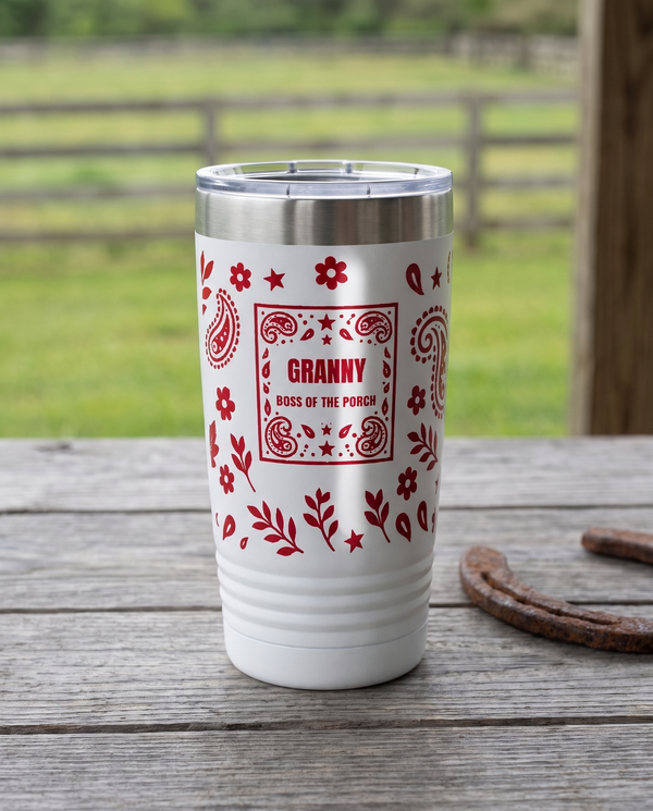 Bandana Paisley, Boss of the Porch wrap on a white 20oz tumbler personalized GRANNY, BOSS OF THE PORCH, a weathered barnwood table on a ranch porch