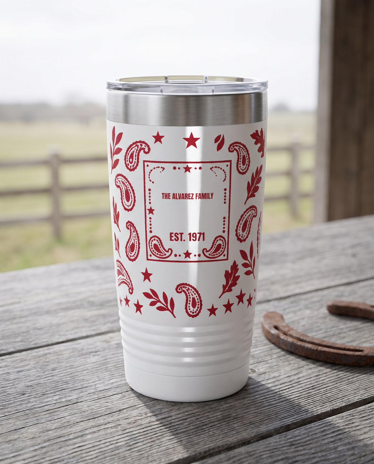 Bandana Paisley, Family Name wrap on a white 20oz tumbler personalized THE ALVAREZ FAMILY, EST. 1971, a weathered barnwood table on a ranch porch