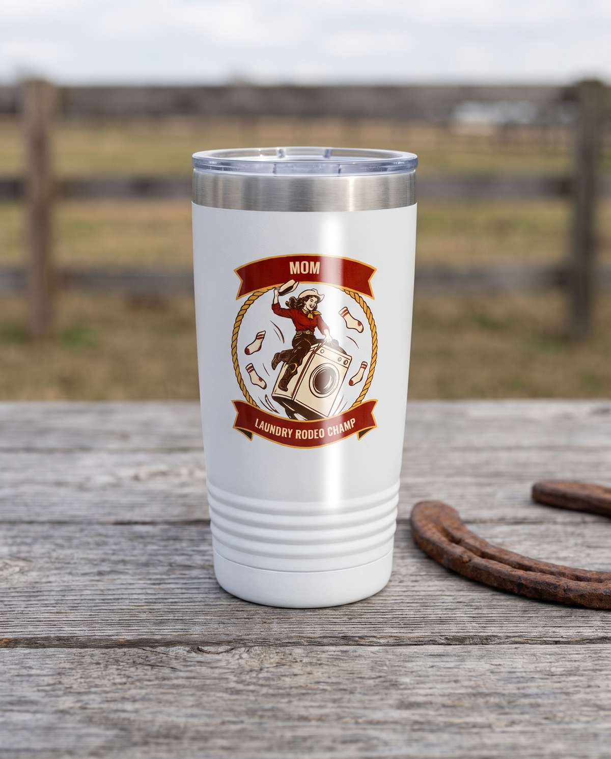 Rodeo Program, Laundry Rodeo Champ badge on a white 20oz tumbler personalized MOM, LAUNDRY RODEO CHAMP, a weathered barnwood table on a ranch porch