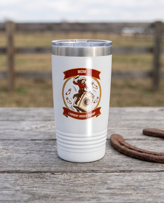 Rodeo Program, Laundry Rodeo Champ badge on a white 20oz tumbler personalized MOM, LAUNDRY RODEO CHAMP, a weathered barnwood table on a ranch porch