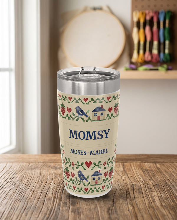 Cross-Stitch Sampler, a cross-stitch sampler in red, green, navy and cream, printed all the way around a 20oz Ringneck tumbler in White, sample name MOMSY