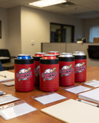12oz Can Cooler with a custom full-color printed logo, set out for a company event | Karved Concepts