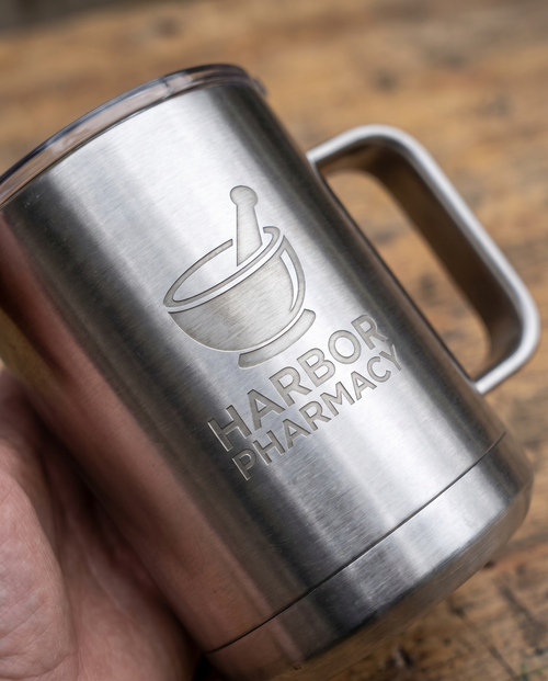15oz Stainless Mug with a custom laser-engraved logo, close-up of the decoration | Karved Concepts