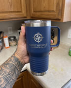 20oz Travel Mug with a custom laser-engraved logo, in hand to show size | Karved Concepts