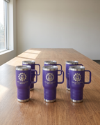 20oz Travel Mug with a custom laser-engraved logo, set out for a company event | Karved Concepts