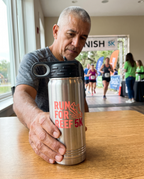 20oz Water Bottle, UV printed with a sample business logo (illustrative lifestyle image)