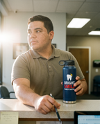 32oz Water Bottle, UV printed with a sample business logo (illustrative lifestyle image)