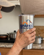 20oz Ringneck Tumbler, UV printed with a sample business logo (illustrative image, in hand for scale)