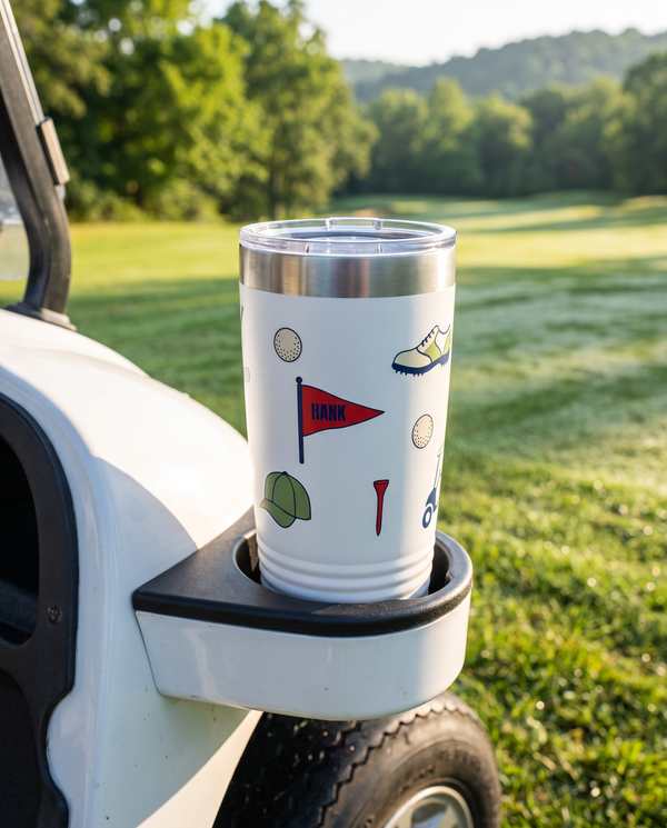 Bag Drop Pennant personalized golf tumbler in a golf cart cup holder beside the fairway