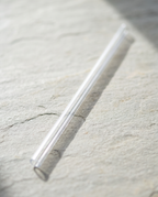 Clear 40oz travel mug replacement straw on its own, on slate