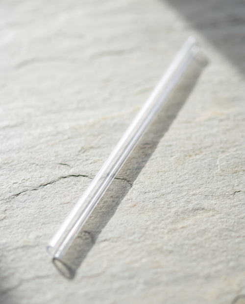 Clear 40oz travel mug replacement straw on its own, on slate