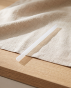 Frosted water bottle replacement straw on its own, on a linen towel