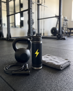 20oz Water Bottle, on a gym floor | Karved Concepts