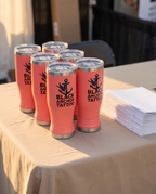 14oz Pilsner Tumbler with a custom full-color printed logo, set out for a company event | Karved Concepts