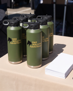 40oz Water Bottle with a custom full-color printed logo, set out for a company event | Karved Concepts